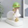 Souvenir Polystone Light "Baby in a green hat, with a gold bubble at the ball" 16.5x8x16 cm