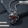 The pendant "Skull with patterns" bright eyes, red color in black silver, 70 cm