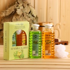 A set of shampoos with a white washcloth 