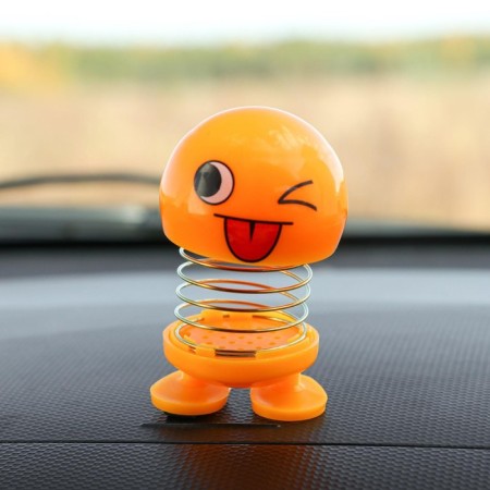 Smile on the spring, on the panel in the car, winks, yellow
