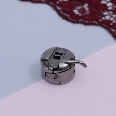 Bobbin cap to BSHM, left, 3 × 2.5 × 1.5 cm-1