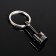 Cartage keychain, piston, metal, black