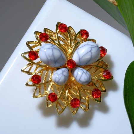 Brooch "Butterfly" on the flower, the color is white-red in gold