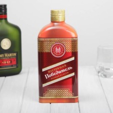 A tin box in the shape of a bottle for strong alcohol 