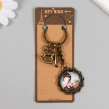 A metal keychain, glass with a carbine 