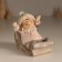 Souvenir Polystone "Baby in a sled, flies from the hill" Pink 9x7.8x9 cm