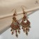 Hanging earrings with rhinestones "East" fan, red color in black gold, 9cm