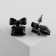 Earrings with a ostric "bow" with a rectangle, the color is black