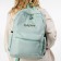A backpack with a zipper, 3 outer pockets, green color
