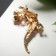 Brooch "Lizard" is tropical, the color is pink green in gold