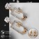 Earrings with rhinestones "flutter" butterflies in a rectangle, white color in gold