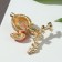 Brooch "Chick" on a branch, colored in gold