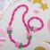Children's “chosen” set 2 items: beads, bracelet, flowers are large, bright pink color