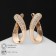 Earrings with rhinestones "Magic" curl, white color in gold