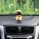 Dog on a car panel shocking his head, dog