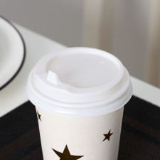 A plastic disposable lid for a white glass, with a valve, d = 8 cm