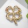 Brooch "Clover" contour, emerald color in gold