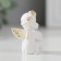 Souvenir Polystone "Angel with handles on the knees sits" White with gold 4x3x2 cm