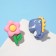 Earrings plastic "goodies" dinosaur and flower, the color of the blue pink