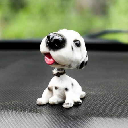 Dog on a car panel shocking his head, Dalmatian