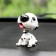 Dog on a car panel shocking his head, Dalmatian