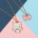 Kulons "Demetrons" cat with a bow, white-pink color in gold, 45 cm