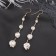 Hanging earrings with rhinestones "Drop" path, white color in gold, 6.2 cm