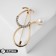 Brooch "Stetoscope", white color in gold