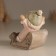 Souvenir Polystone "Baby in a sled, flies from the hill" Pink 9x7.8x9 cm