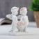 Polystone souvenir "Snowty angels in pink wreaths with roses basket" 9x9x3.5 cm