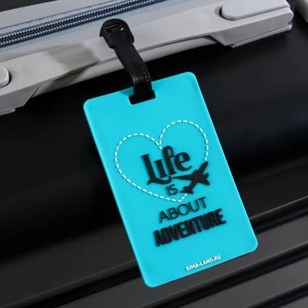 Tag on a rubber suitcase "Life is ABOUT Adventure", turquoise