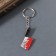 Acryl key a mirror "bloodied test" 4.6x1.6x0.4 cm