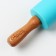 The rocking "Secret ingredient", 31 x 4 cm, silicone, wood, turquoise color
