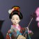 Collectible doll "Geisha in a flower kimono with a musical instrument" 30 cm