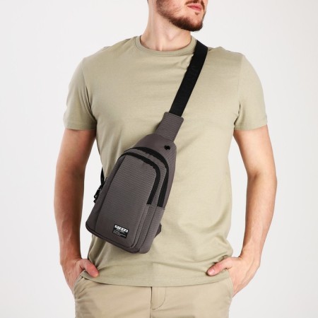 Male sling bag from textiles, headphone opening, gray color