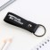 Kezzle keychain to the leatherette "First in everything!", 11 x 2.5 cm