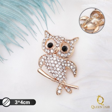 Brooch "Owl on a twig", black and white color in gold