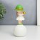 Souvenir Polystone "Baby in a green hat, with a gold bubble on the ball" 16x7x7 cm