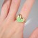 Ring "Heart" fluid, green color in gold, dimensionless