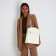 Women's backpack made of artificial leather with lightning, 3 pockets, milk color