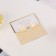 A wedding invitation with the ribbon "for our wedding"