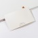Invitation to a wedding with a golden ribbon, carved, white