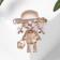 Brooch "Girl" in a hat, colored in gold