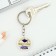 A keychain for graduation "graduate", diam. 3 cm
