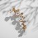 Earring "caffe" chamomile with rhinestones, white color in gold, l = 5 cm