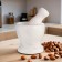 A mortar with a pestle made of stone is medium, 250 ml, white, in a box