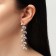Hanging earrings with rhinestones "Blink" with leaves, white color in gold, 8 cm