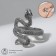 The ring "snake" curved, the color is black silver, dimensionless
