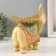 Polystone souvenir "Beige elephant with a gold leaf on the back" 19.3x11x19 cm