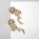 Earrings with rhinestones "flowers" bends, white color in gold